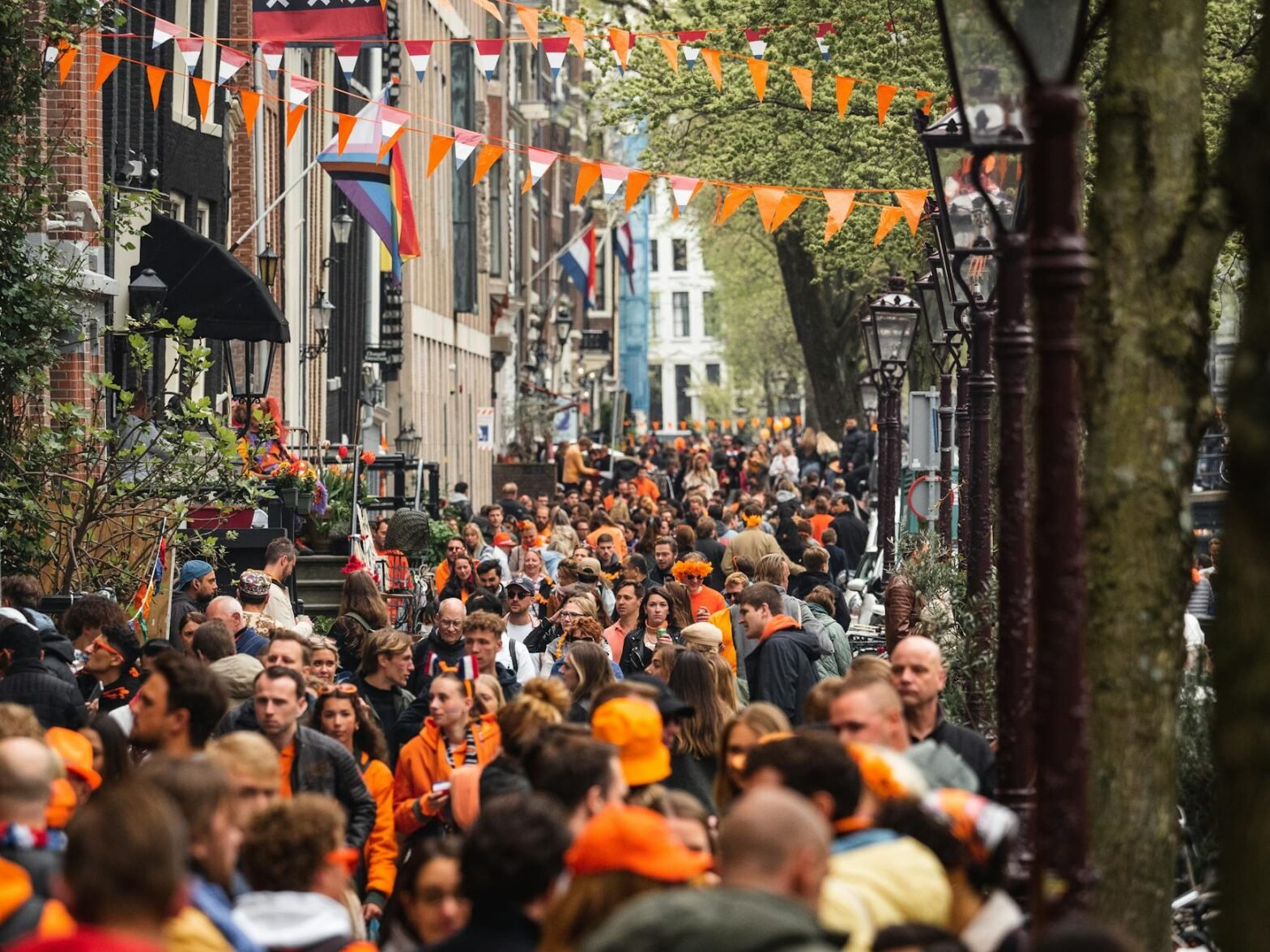 a crowd of people walking down a street