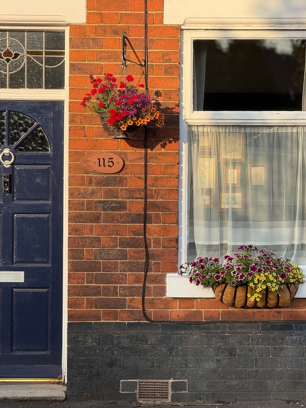charming brick facade with colorful flowers